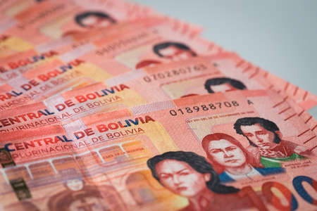 fan of money from Bolivia, hundred Bolivianos banknotes spread on the tableの写真素材