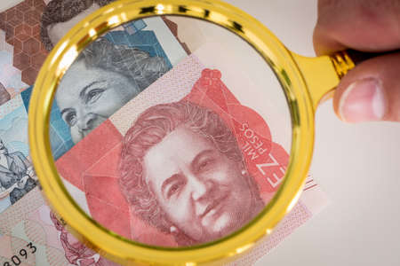 Colombia money. Pesos, Paper Banknotes with a magnifying glass on it. Different values. Business and...