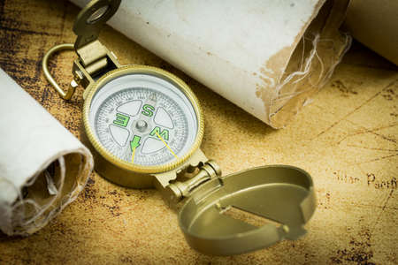 Old maps with a compass. The concept of expeditions and travel, discovering the world