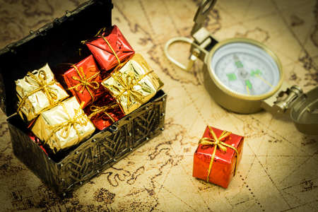 old chest full of gifts, compass, treasure hunt conceptの写真素材