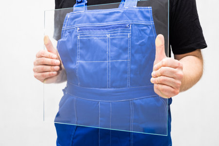 A worker holding a glass in his handsの写真素材