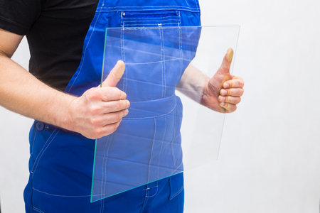 A worker holding a glass in his handsの写真素材