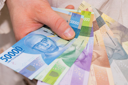 The currency of Indonesia, Rupiah, File of banknotes held in the hand