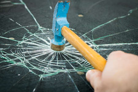 breaking safety glass with a hammerの写真素材