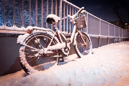A bicycle covered in snow. Concept of rapid weather change, Winter Attackの写真素材