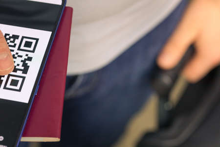 Travelers who have a passport and a phone with a Qr code indicating vaccination against coronavirusの写真素材