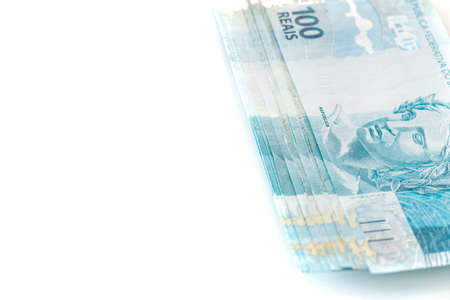 Brazilian money. Lots of 100 Real Banknotes, Banking and Business Concept, White Background, Place...