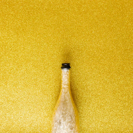 champagne bottle on shiny golden background, Minimal party drink composition, custom textの写真素材