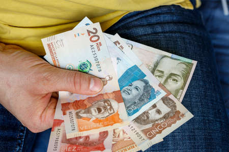 held in hands Colombian money, pesos, various banknotes Economic concept