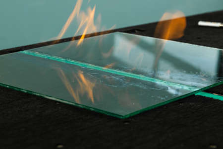 a pile of cut glass pieces and glazier toolsの写真素材