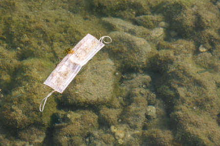 Littering the aquatic environment, Old anti virus mask thrown into the sea