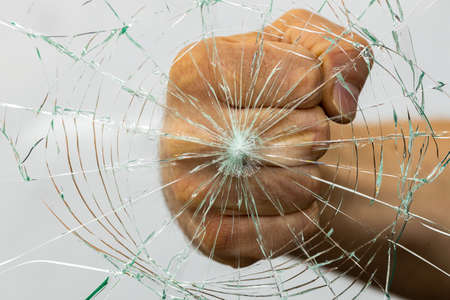 A fist breaking glass, The concept of anger and aggressionの写真素材