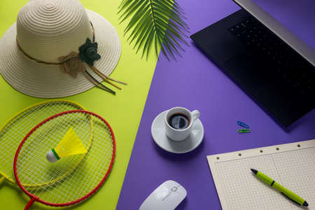 purple green two-color creative frame, One side associated with vacation, Hat, tropical leaves, badminton rackets, The other side, things associated with work, Computer, coffee, office notebook, Concept, digital nomad, balance of work and life.の写真素材