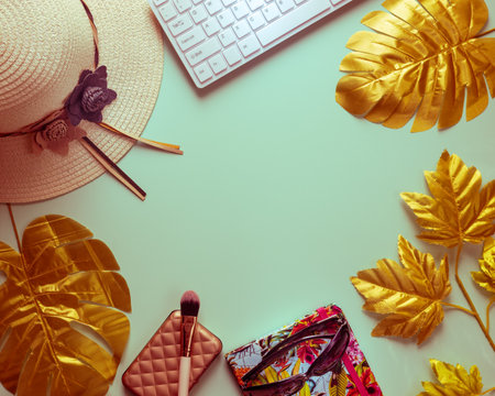 Flat creative frame of tropical nature, abstract colors, golden leaves monstery laptop, Women's hat, colorful notebook with sunglasses, Concept, digital nomad, work balance life. Background with space for textの写真素材