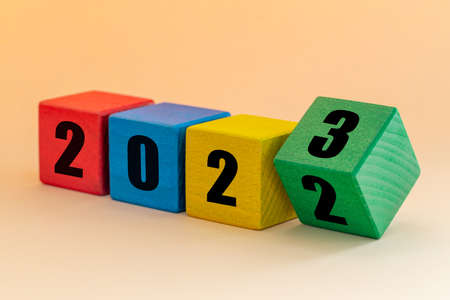 2022 to 2023, Numbers on joyfully colored blocks, Merry Christmas and a Happy New Year, Apricot backgroundの写真素材