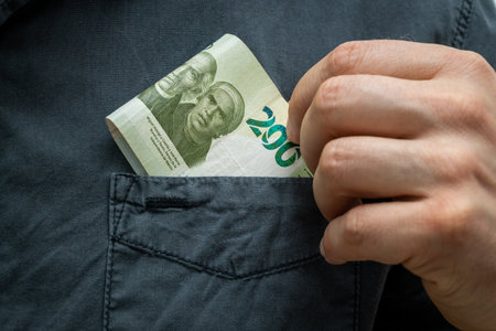 Mexican money. A 200 peso banknote pulled out of a shirt pocketの写真素材