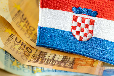 The flag of Croatia against the background of the single currency of the European Union, The concept of Croatia joining the Euro zoneの写真素材