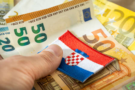 The flag of Croatia against the background of the single currency of the European Union, The concept of Croatia joining the Euro zoneの写真素材