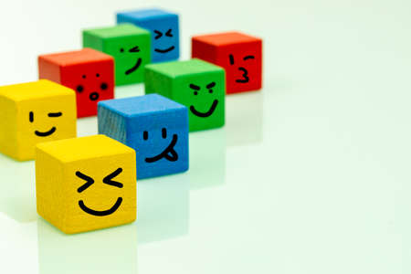 Colorful wooden blocks with emoticons Positive emotions, smiles, facial expressions, Concept of positive thinking and expressing feelingsの写真素材