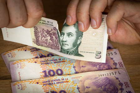 Argentine Peso, Financial Crash, Valuable Currency, Hands Ripping Money, Financial Concept, Rising...