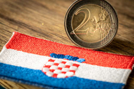 Croatian flag next to the euro coin. Croatia's accession to the Euro zone. Concept, Flag of the Country, Political and economic concept of the European Unionの写真素材