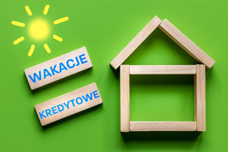 Holidays Kredytowe text in Polish denoting credit holidays, State program to help borrowers in Poland repay loans during the crisis, Creative concept, Home and written with blocksの写真素材