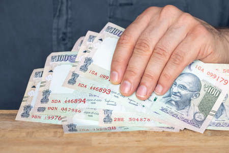 Indian rupees, File of banknotes held in the hand, Concept of financial success, winning or a hit...