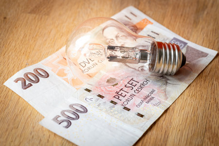Czech money CZK 700 and a light bulb, Concept of increasing energy and electricity prices in the Czech Republicの写真素材