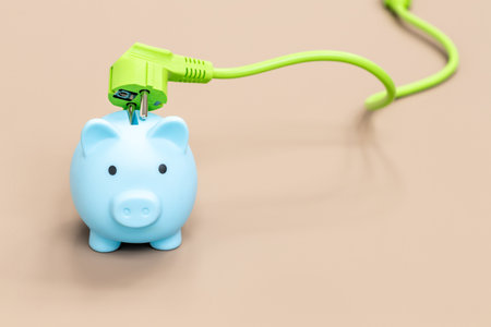 Piggy bank and green electric cable, Environmental concept promoting natural and economical sources of energy, Modern technologies of obtaining green energy, place for an inscriptionの写真素材