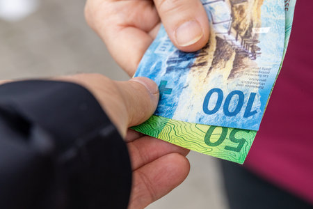 the woman gives the man money, Swiss Francs, Transferring money, Financial concept