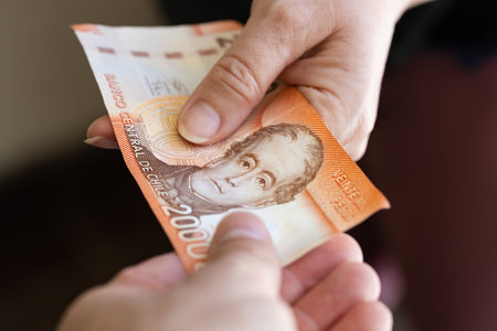 Chile 20 thousand pesos, banknote, Passing money from hand to hand, Financial and business concept, Chile's highest denomination banknote, Passing cash to each otherの写真素材