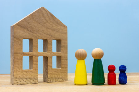 Dream house, Happy family with children standing in front of their own house, Wooden figures,...