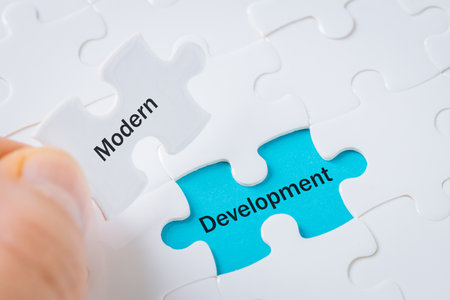 modern development, puzzle revealing text, business conceptの写真素材