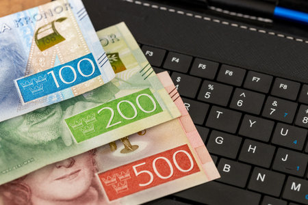 E-commerce business, Sweden, money on tablet keyboard, Shopping and online stores, concept, online marketplace, Secure Payments and bank transfers in Swedenの写真素材