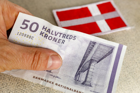 Denmark Money, 50 danish kroner banknote together with national flag, Financial and business concept, close upの写真素材