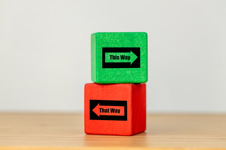 Making the right decisions, green and red wooden block with arrows in opposite directions. Text this way and that, Concept, Difficult decision, Business direction, Life decisionの写真素材