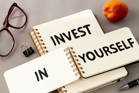 Invest in yourself, Business notebook lettering, Beautiful toned gray background, minimalist concept