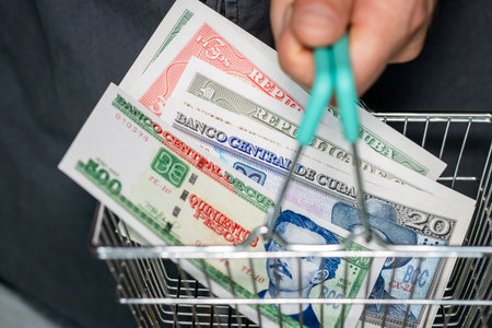Cuban Pesos Banknotes in Shopping Basket. A man holding a basket of Cuban money in his hand,...