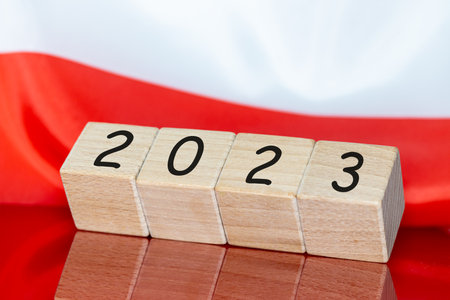 Elections in Poland year 2023, White and red national banner and year 2023 on wooden blocks, Election year concept and encouragement to universal voteの写真素材