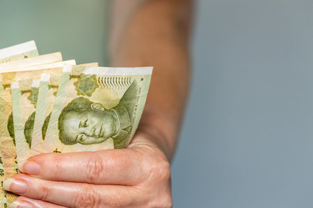 chinese money, Woman holds several 1 yuan banknotes in her hand, Financial conceptの写真素材