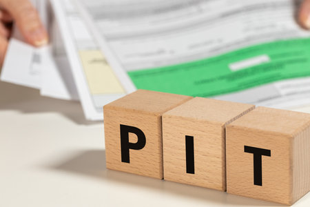 Filing annual tax return in Poland, Personal Income Tax in short PIT text on wooden blocks, person settling tax in Poland, financial conceptの写真素材