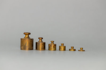 scale weights set from the smallest in a row, copy space, business concept, beautiful gray backgroundの写真素材
