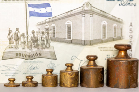 Honduras money, Banknote of 200 Honduran lempiras with set weights from scales, Financial concept, strength of Honduran currencyの写真素材