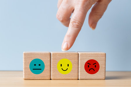 Happiness symbol, Positive mindset, joy index finger, next to wooden cubes with sadness and anger icons,の写真素材