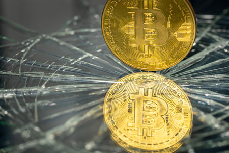 Bitcoin reflecting in broken glass, Cryptocurrency market crash concept, Bitcoin weakening, virtual currenciesの写真素材