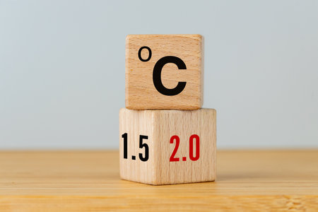 A symbol of the fight against global warming. A rotating wooden cube with symbols of increasing temperature and vice versa. Reducing co2 and reducing human impact on the environment. copy spaceの写真素材