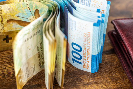 Switzerland money, Stack of unfolded cash next to wallet, Swiss francs, Financial conceptの写真素材