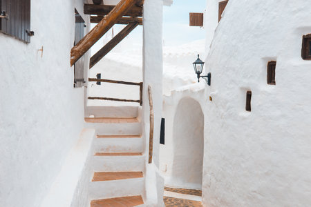 Whitewashed houses of the village of Binibeca. Menorca Island in the Balearic Islands, Spain. Charming architecture of small townsの写真素材