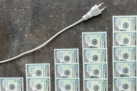 Increasing scale of electricity increases and dollar banknotes that symbolize the huge increase in electricity prices, energy concept, energy crisisの写真素材