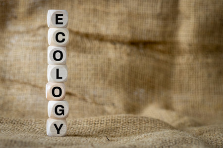 Ecological wording on wooden cubes arranged vertically on a natural jute bag, Environmental concept, copy spaceの写真素材